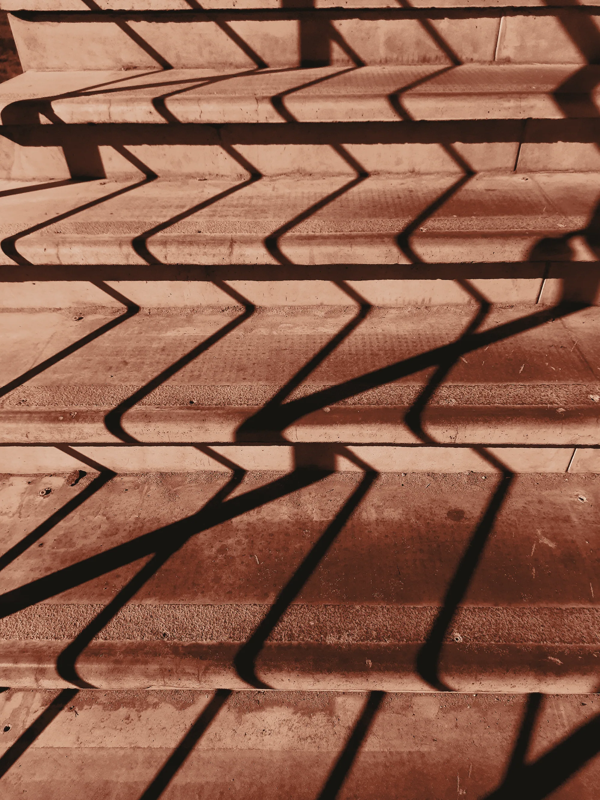 Chevron shadows on steps in rust duotone