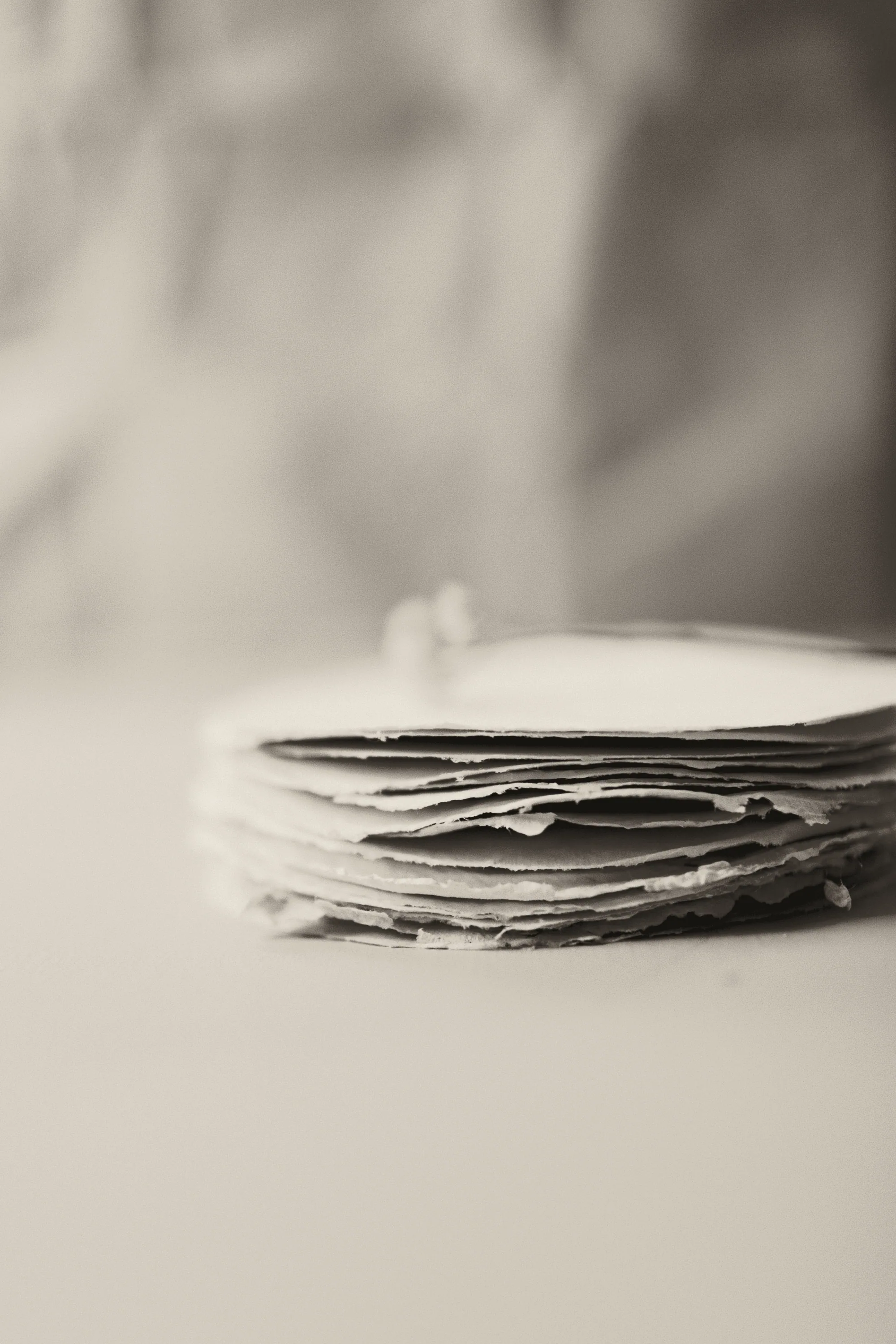 Stack of handmade paper sheets in soft light