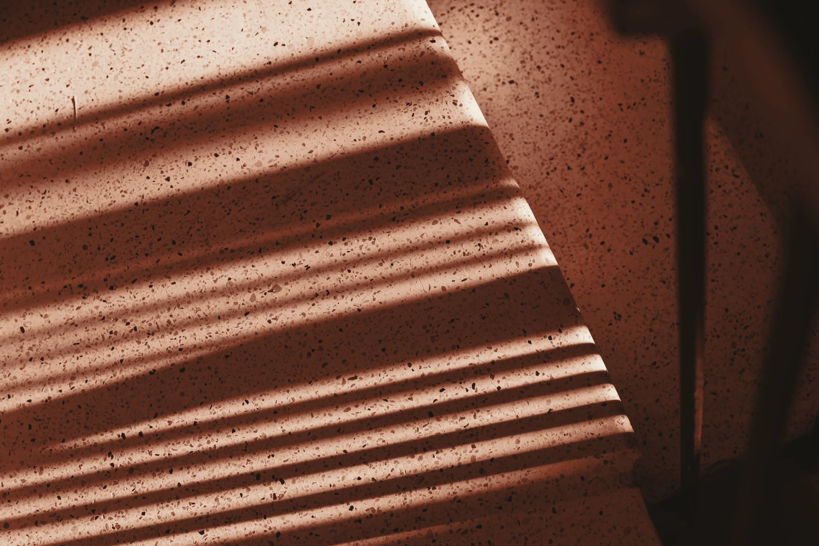 Terrazzo steps in striped light, rust duotone